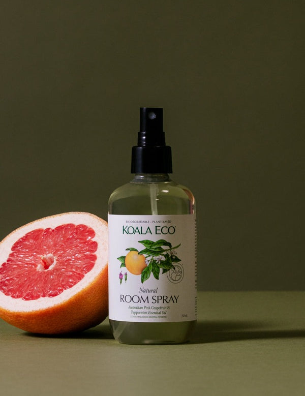 Koala Eco Pink Grapefruit and Peppermint Room Spray styled with fresh grapefruit