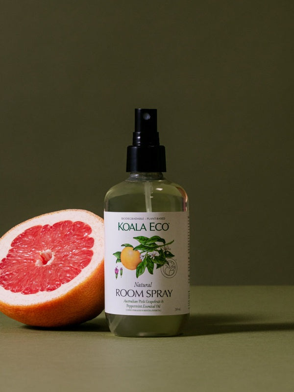 Koala Eco Pink Grapefruit and Peppermint Room Spray styled with fresh grapefruit