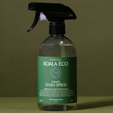 Koala Eco Laundry Stain Spray styled in botanical shadows on a deep green background