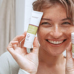 Woman holding Kolorex Horopito Skin Cream and wash beside her face