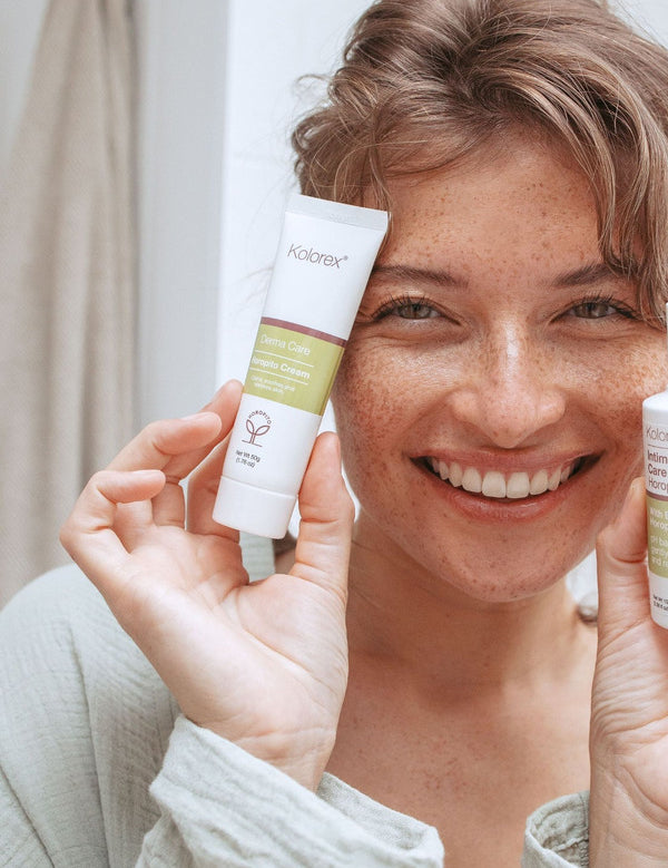 Woman holding Kolorex Horopito Skin Cream and wash beside her face