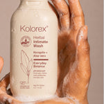 Hands holding Kolorex Herbal Intimate Wash Everyday Balance with cleansing foam