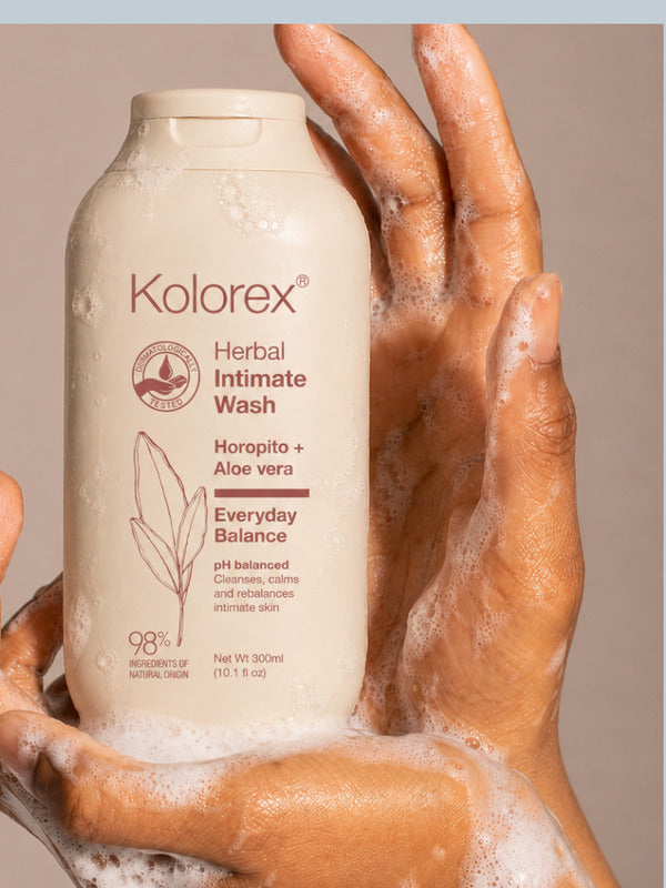 Hands holding Kolorex Herbal Intimate Wash Everyday Balance with cleansing foam