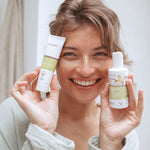 Woman holding Kolorex Horopito Skin Cream and wash beside her face