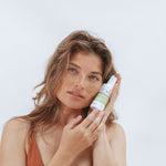 Woman holding Kolorex Intimate Care Horopito Wash beside her face