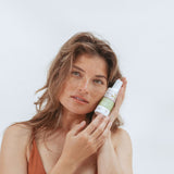 Woman holding Kolorex Intimate Care Horopito Wash beside her face