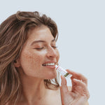 Woman applying Kolorex Kolsore Lip Ointment