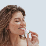 Woman applying Kolorex Kolsore Lip Ointment