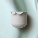 KORA Organics Active Algae Lightweight Moisturiser refill pod set against a soft green cream texture.
