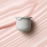 KORA Organics Berry Bright Vitamin C Eye Cream refill pod set against a soft pink cream texture.