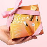 KORA Organics Best Sellers Trio: Hand holding the orange gift box tied with a pink ribbon.