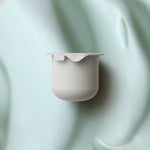 KORA Organics Active Algae Lightweight Moisturiser refill pod on a soft green cream-texture background