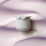 KORA Organics Plant Stem Cell Retinol Alternative Moisturiser refill pod on a soft lilac cream-texture background