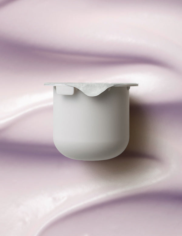 KORA Organics Plant Stem Cell Retinol Alternative Moisturiser refill pod set against a soft lilac cream texture.