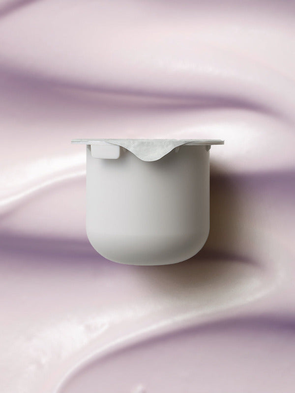 KORA Organics Plant Stem Cell Retinol Alternative Moisturiser refill pod set against a soft lilac cream texture.