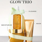 KORA Organics Turmeric Glow Trio: The three skincare products arranged with a pale green ribbon and cleanse, mask and moisturise labels.
