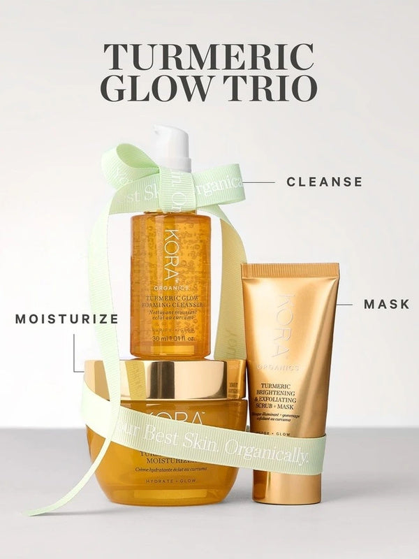 KORA Organics Turmeric Glow Trio: The three skincare products arranged with a pale green ribbon and cleanse, mask and moisturise labels.