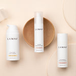LAMAV Age-Defence skincare essentials arranged on a warm neutral surface