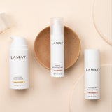 LAMAV Age-Defence skincare essentials arranged on a warm neutral surface