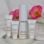 LAMAV Age-Defence discovery products styled with fresh pink flowers