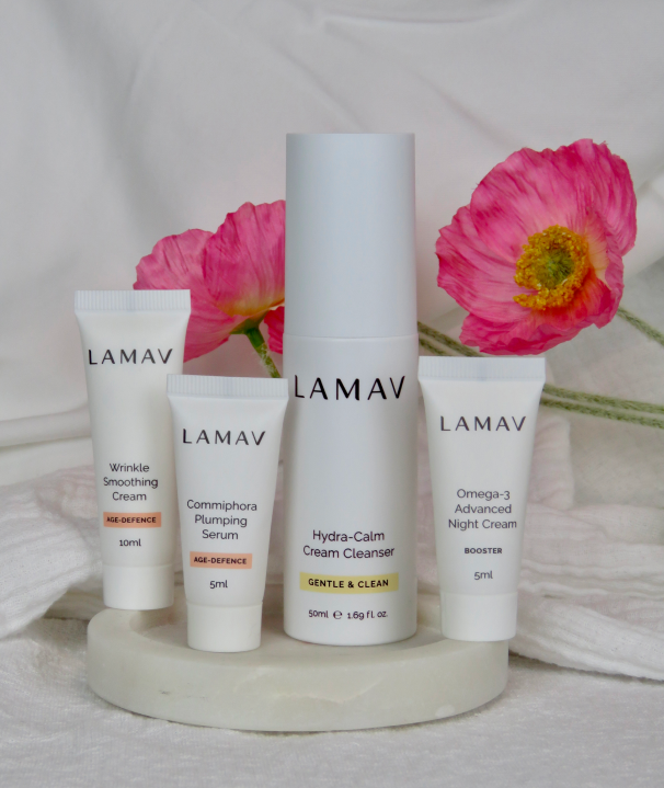 LAMAV Age-Defence discovery products styled with fresh pink flowers