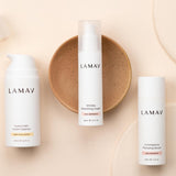 LAMAV Age-Defence Skin Discovery trio on peach, with Hydra-Calm Cream Cleanser, Wrinkle Smoothing Cream and Commiphora Plumping Serum.