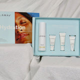 Open pale blue LAMAV Hydration Skin Discovery Pack displaying one white bottle and three small tubes on draped white fabric.