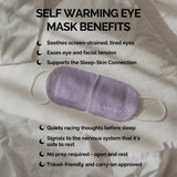 Purple LAMAV Lavender Self Warming Eye Mask with white ear loops on cream bedding. Brand text lists eye comfort, easing tension, winding down before sleep, no preparation and travel use.