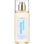 A clear bottle of Lavanila Healthy Hair and Body Mist Vanilla Coconut with a gold spray nozzle and blue label, containing 150ml of vegan fragrance for hair and body.