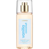 A clear bottle of Lavanila Healthy Hair and Body Mist Vanilla Coconut with a gold spray nozzle and blue label, containing 150ml of vegan fragrance for hair and body.
