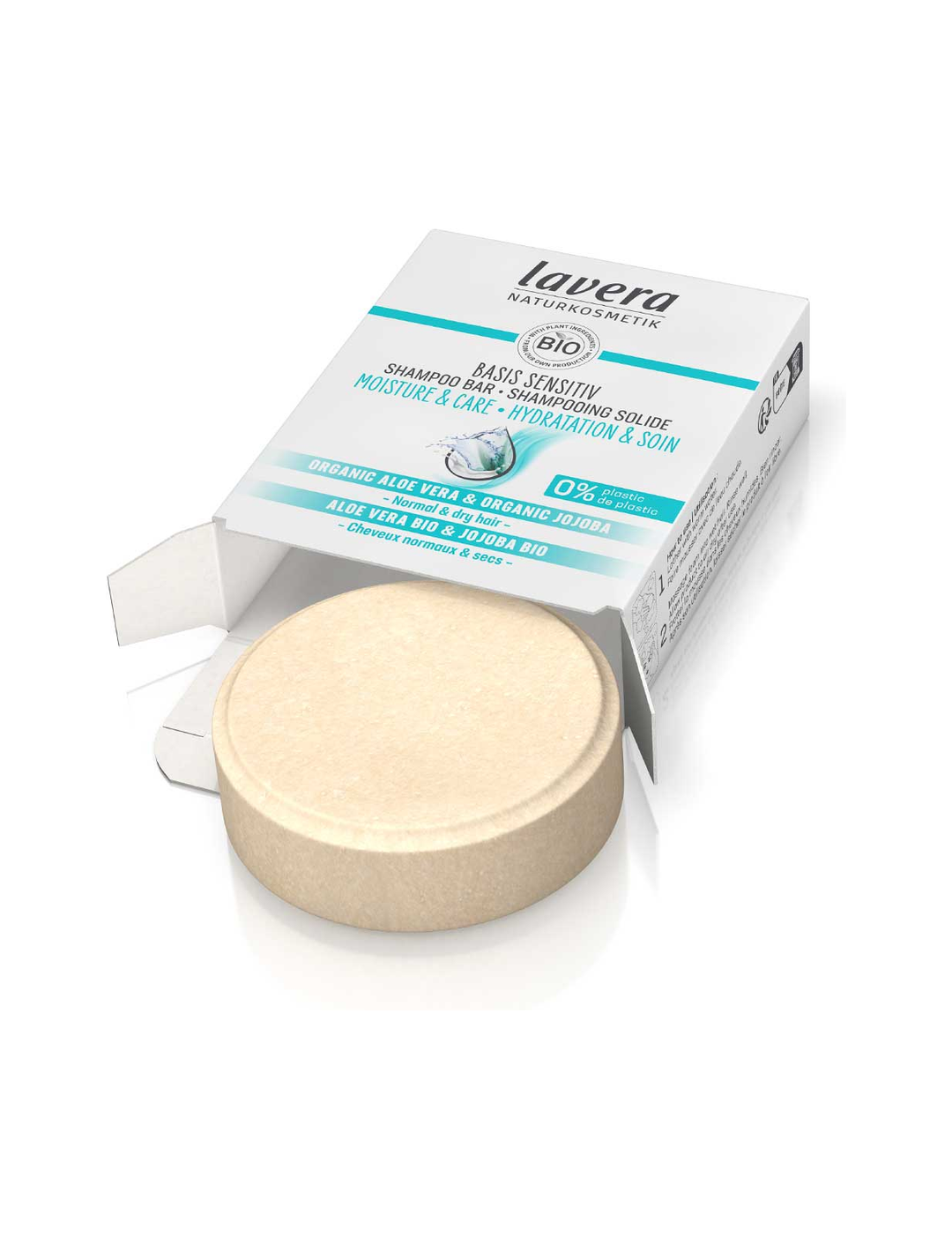 Round pale beige Lavera shampoo bar sitting partly outside an open white cardboard box with turquoise stripes and water-droplet graphics, against white.