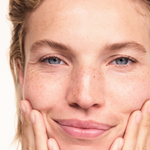 Woman applying Lavera Basis Sensitive Cleansing Milk