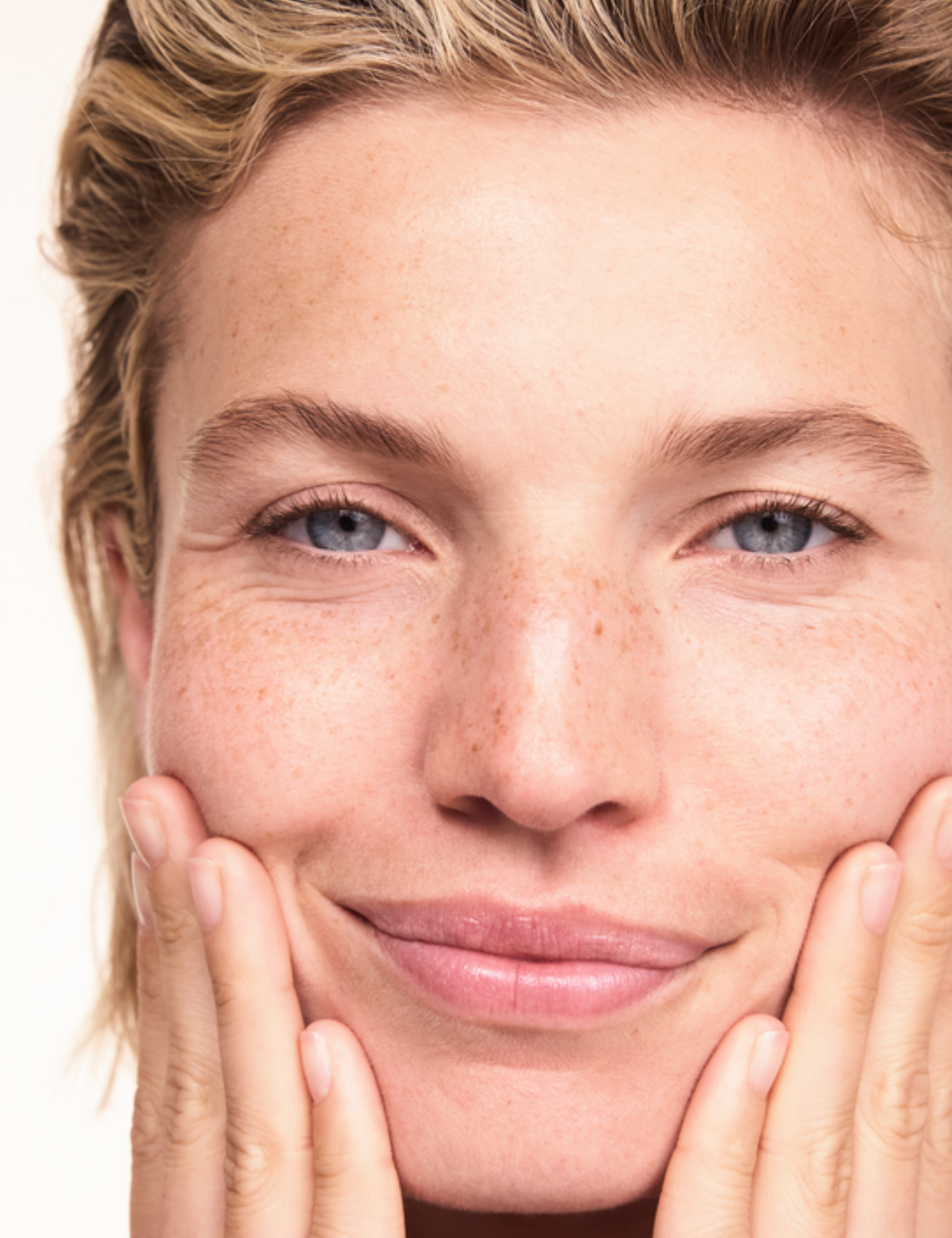 Woman applying Lavera Basis Sensitive Cleansing Milk
