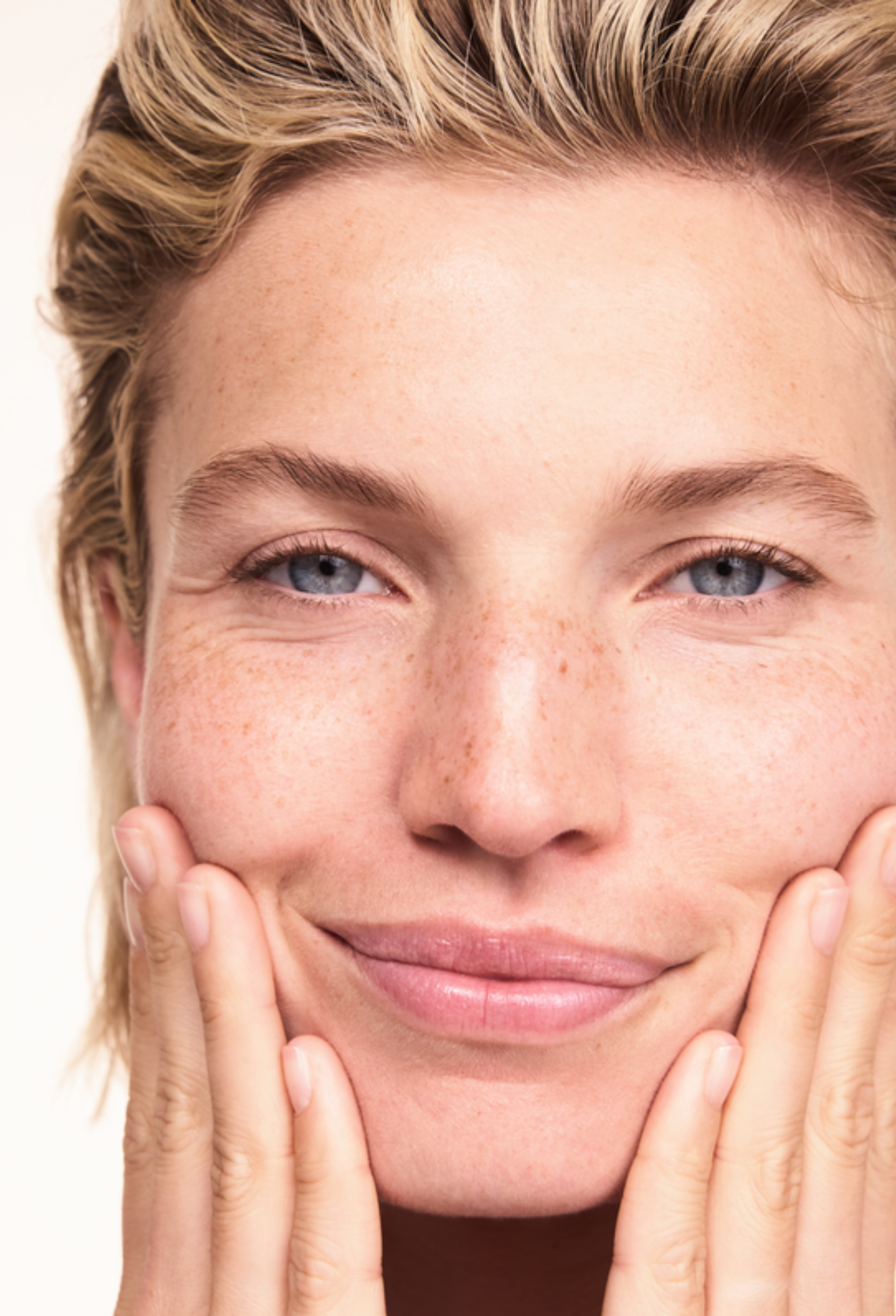 Woman applying Lavera Basis Sensitive Cleansing Milk