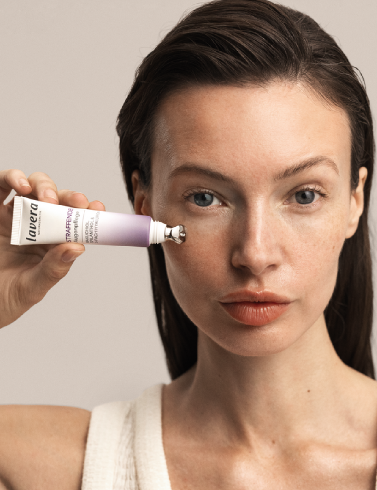 Woman applying Lavera Firming Eye Cream