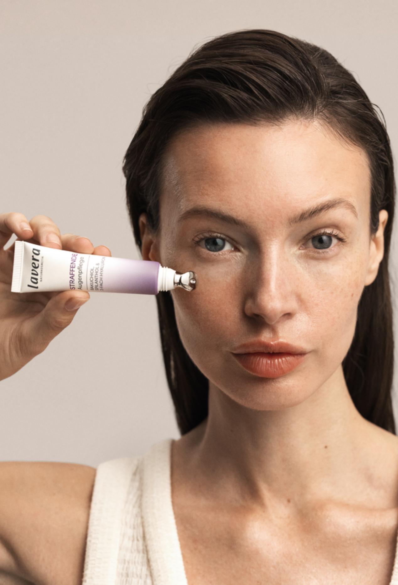 Woman applying Lavera Firming Eye Cream