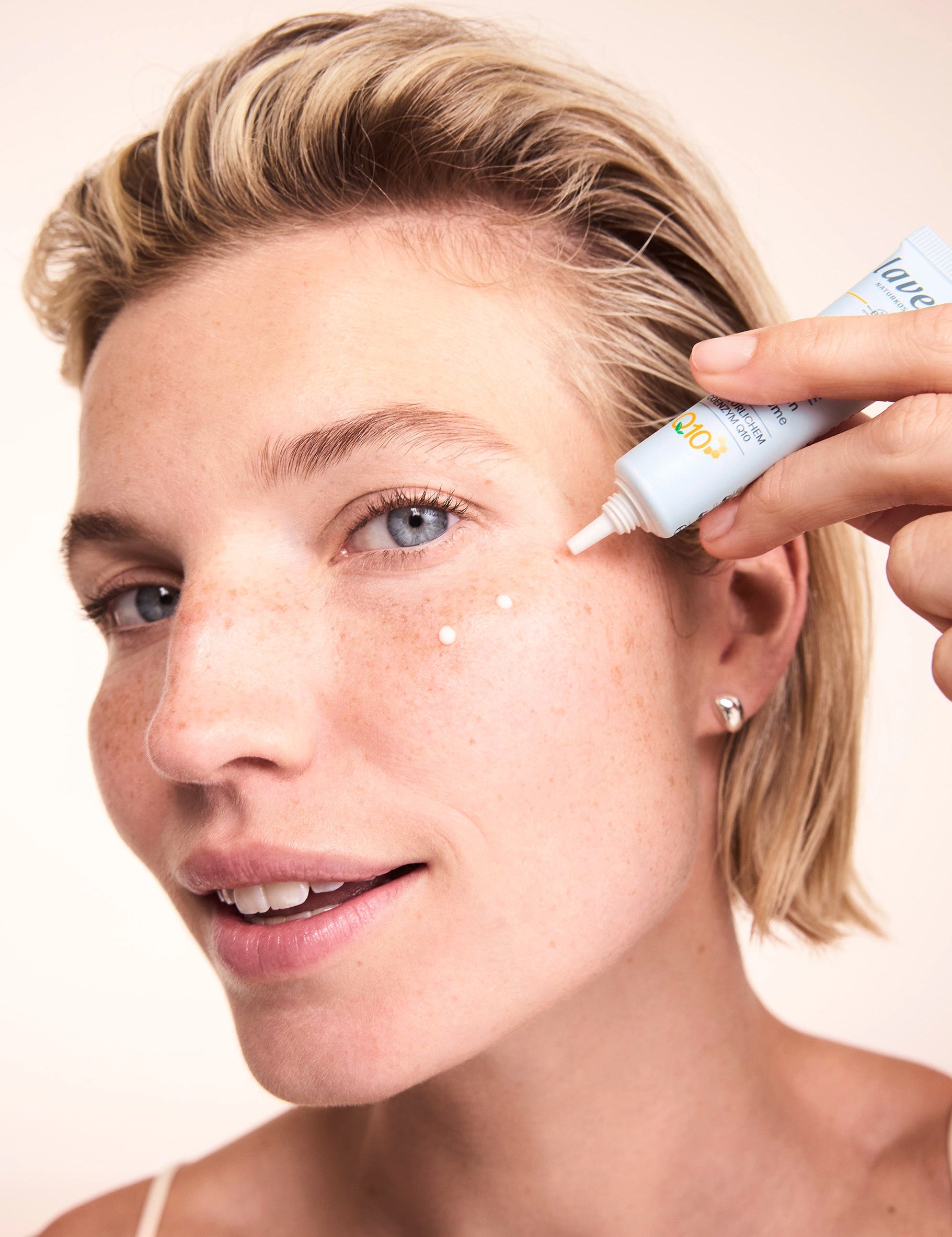 Woman applying Lavera Basis Sensitive Q10 Eye Cream