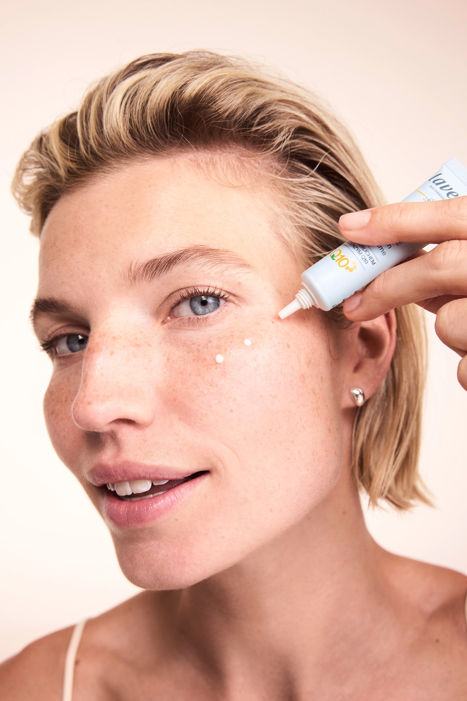 Woman applying Lavera Basis Sensitive Q10 Eye Cream
