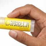 Hand holding Hurraw! Organic Lip Balm - Lemon 4.8g