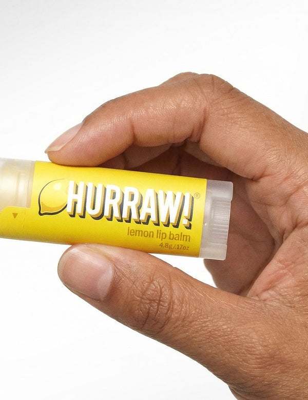 Hand holding Hurraw! Organic Lip Balm - Lemon 4.8g