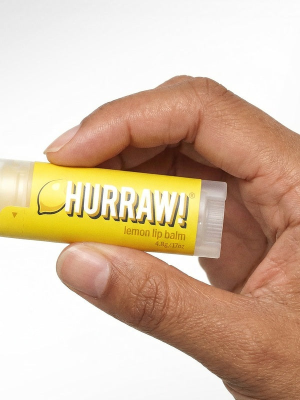 Hand holding Hurraw! Organic Lip Balm - Lemon 4.8g