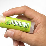 Hand holding Hurraw! Organic Lip Balm - Lime 4.8g