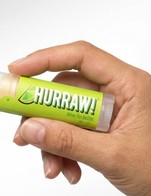 Hand holding Hurraw! Organic Lip Balm - Lime 4.8g