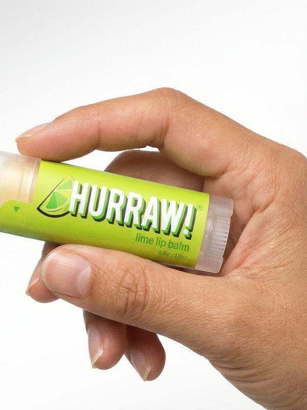 Hand holding Hurraw! Organic Lip Balm - Lime 4.8g
