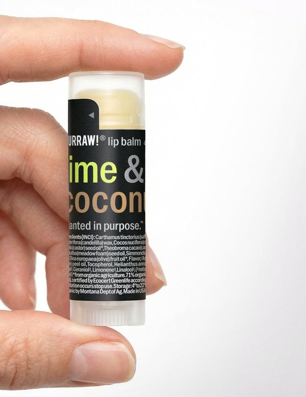 Hand holding Hurraw! Lime & Coconut Lip Balm 4.8g
