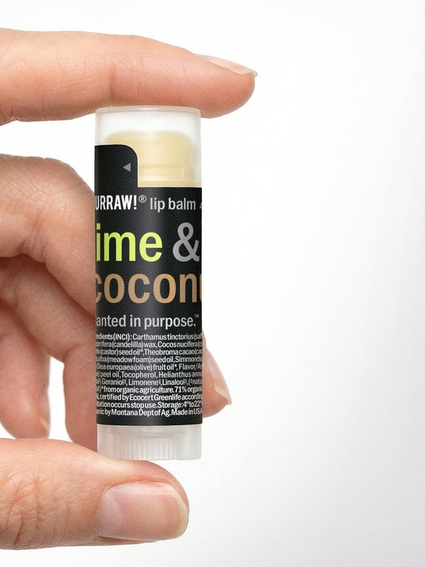 Hand holding Hurraw! Lime & Coconut Lip Balm 4.8g
