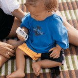 Child holding Little Urchin Baby Natural Zinc Stick Sunscreen SPF50+