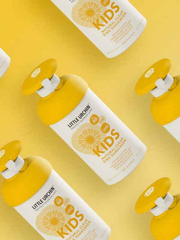 Little Urchin Kids Natural Clear Zinc Sunscreen SPF50+ 300g — yellow 300g pump bottles arranged on a yellow background.