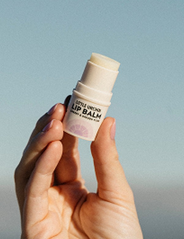 Little Urchin cherry and Kakadu plum lip balm held in hand