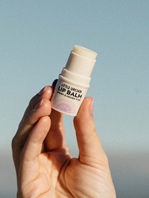 Little Urchin cherry and Kakadu plum lip balm held in hand